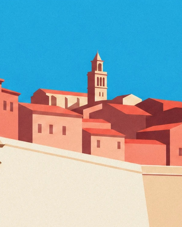 The bell tower and red roofs of Antibes behind the cream rampart