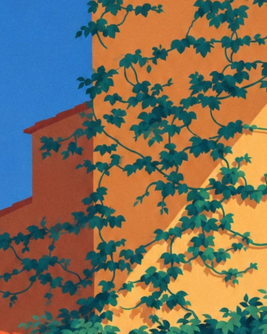 Ivy stems on the ochre façade beneath tiled roofs and a blue sky