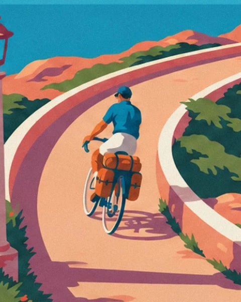 The touring cyclist in blue with orange panniers on the winding coastal road