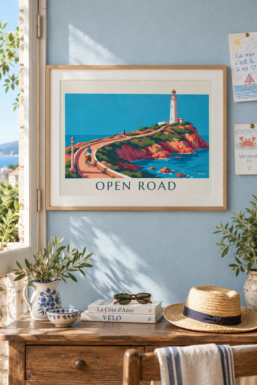 Poster of a touring cyclist with panniers on a coastal road: framed on the wall