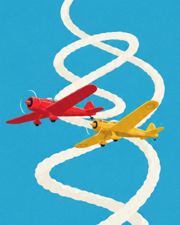 A red plane and a yellow plane spiralling through their white smoke trails