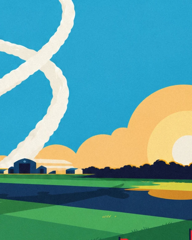 The blue hangars at the edge of the airfield, beneath a large setting sun and swirls of smoke