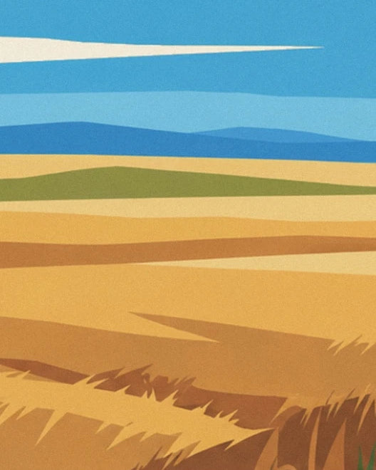 Golden wheat fields in broad strips, blue hills in the distance and ears of wheat below