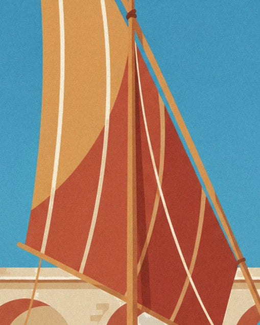 The boat’s ochre and red sails crossed by pale ropes against a blue sky