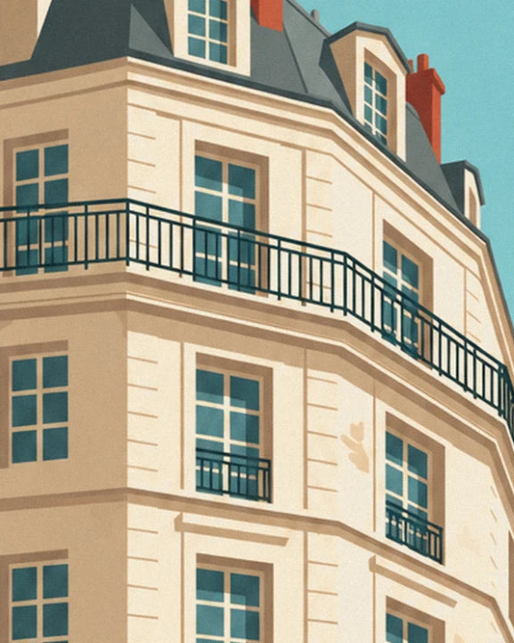 Cream building façade with a wrought iron balcony, slate roof and dormer windows beneath a blue sky