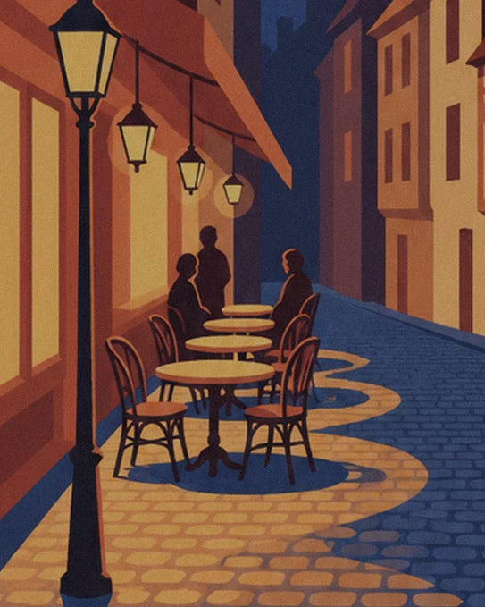 The café terrace beneath the street lamp, with 3 figures seated at tables on the blue cobbles