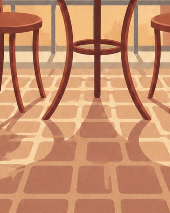 Les pieds de la table de bistrot et des 2 chaises, avec leurs ombres sur les dalles ocre