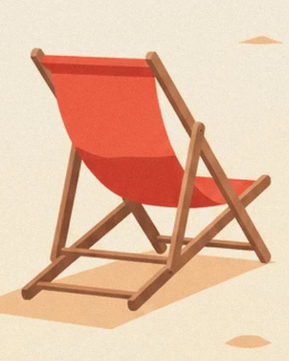 A red deckchair with a wooden frame on the pale sand of Deauville