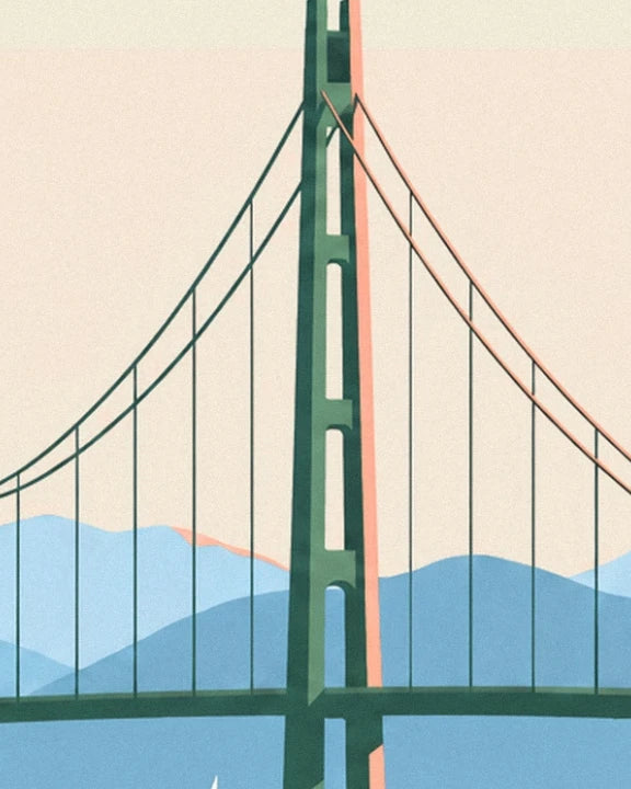 The green tower of Lions Gate bridge and its cables against the blue mountains