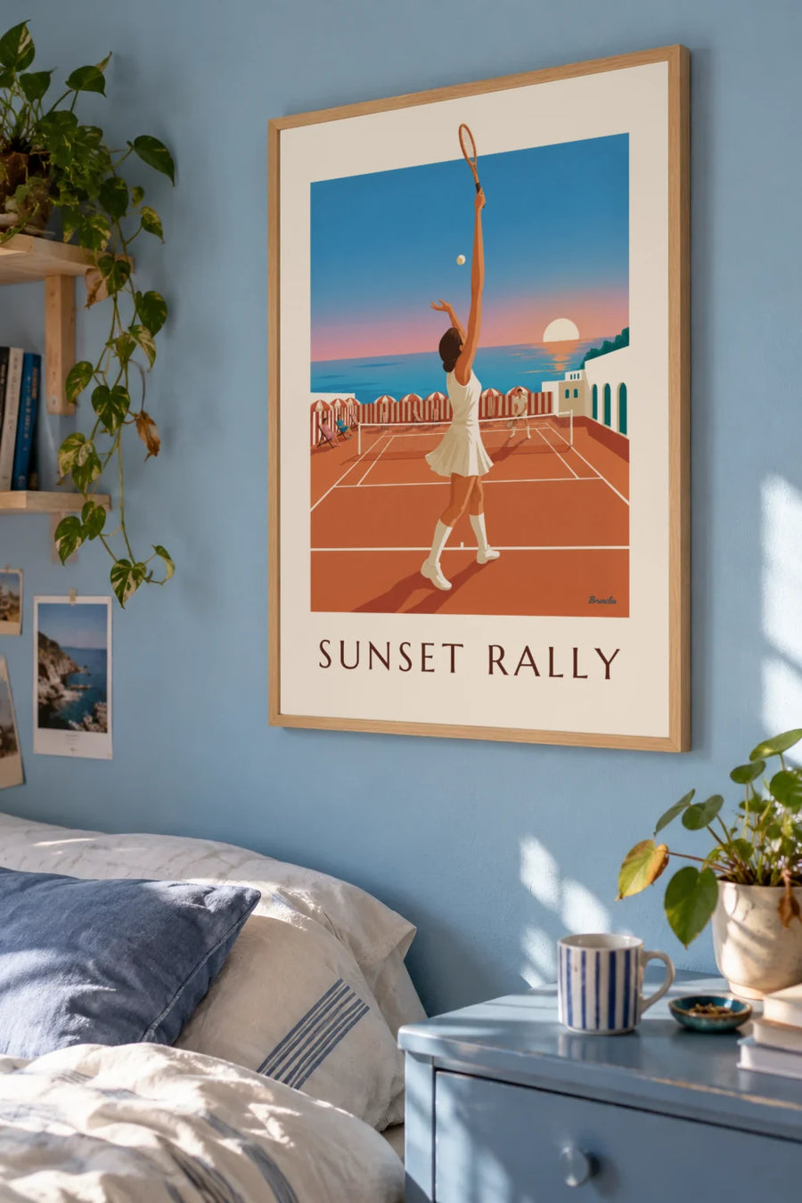 Poster of a tennis court and parasols at sunset: framed on the wall